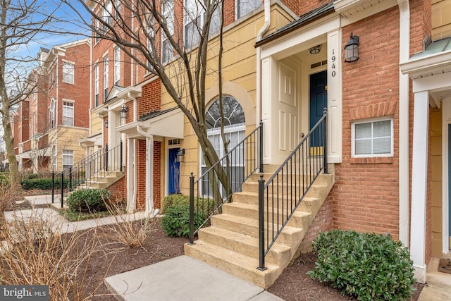 property entrance featuring brick siding