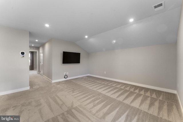 unfurnished living room featuring carpet floors, recessed lighting, visible vents, vaulted ceiling, and baseboards