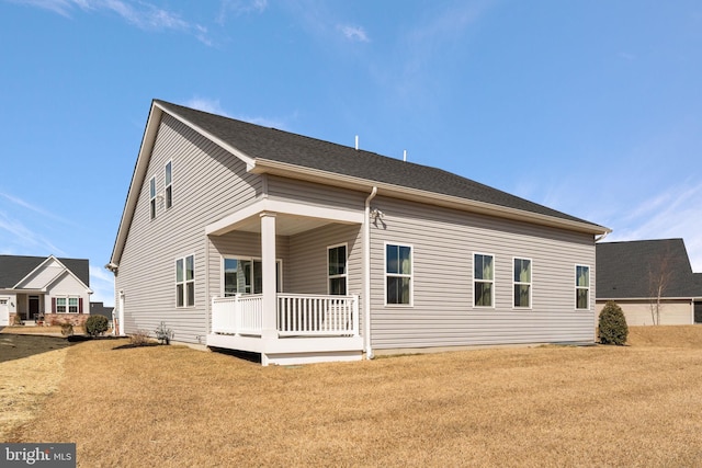 back of property with a porch and a lawn