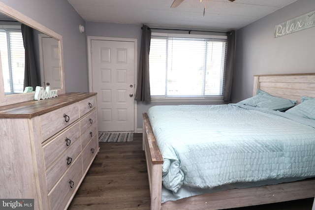 bedroom with dark wood-type flooring