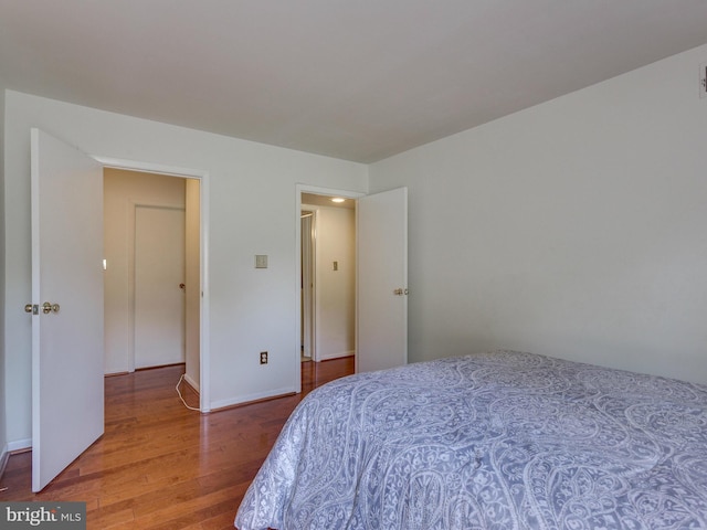 bedroom featuring baseboards and wood finished floors