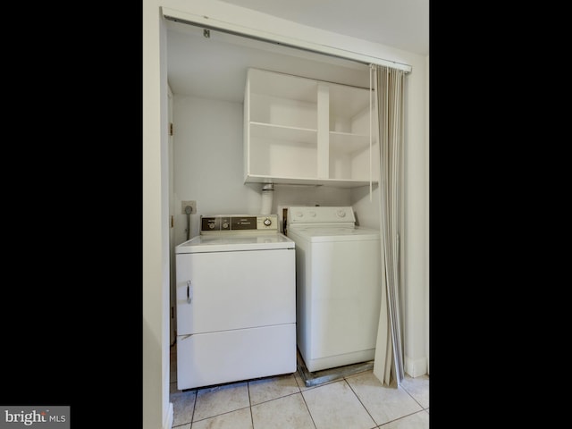 washroom with laundry area, light tile patterned flooring, and independent washer and dryer