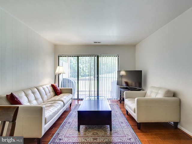 living room featuring dark wood-style flooring and visible vents