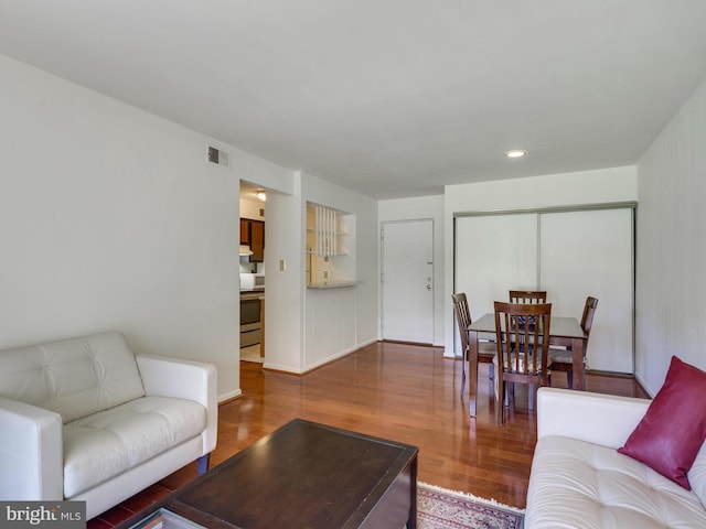 living room featuring visible vents and wood finished floors