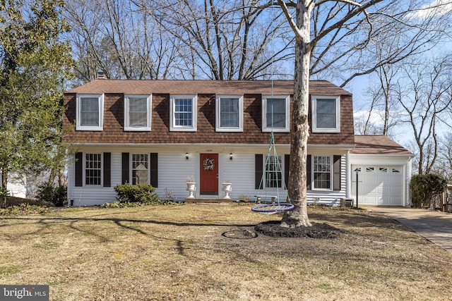 view of front facade featuring a front yard, concrete driveway, roof with shingles, and an attached garage