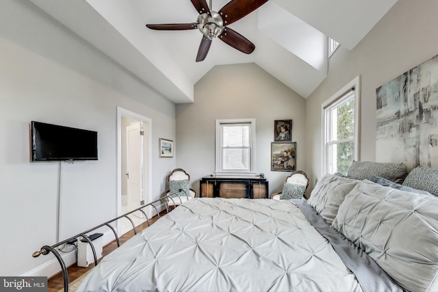 bedroom with baseboards, a ceiling fan, lofted ceiling, and wood finished floors