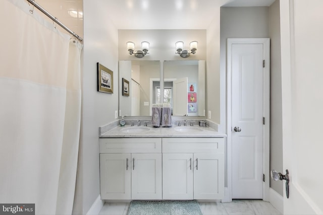 full bath with a sink and double vanity