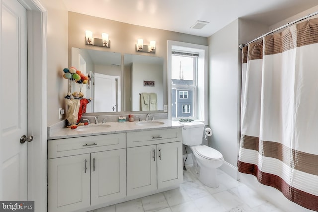 full bath featuring a sink, visible vents, toilet, and double vanity