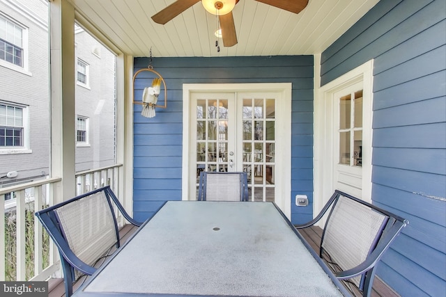 exterior space featuring french doors, outdoor dining area, and a ceiling fan