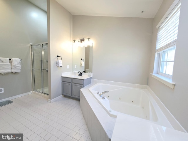 bathroom featuring a stall shower, tile patterned flooring, a tub with jets, and vanity