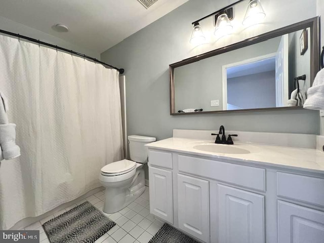 bathroom featuring toilet, tile patterned flooring, and vanity