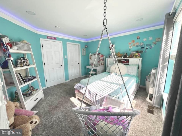 bedroom featuring baseboards, ornamental molding, and dark carpet