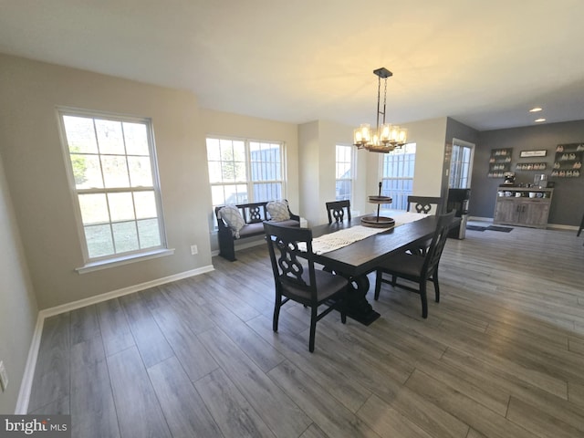 dining space featuring dark wood-style floors, recessed lighting, baseboards, and an inviting chandelier