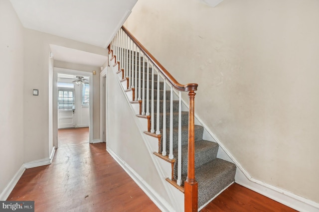 stairs with baseboards and wood finished floors