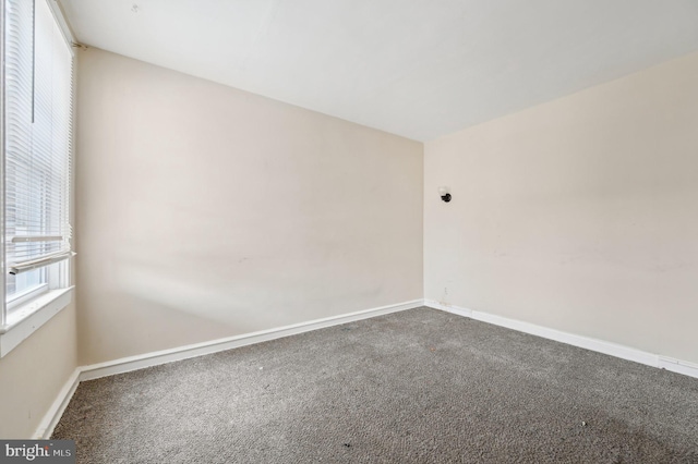 carpeted spare room with baseboards