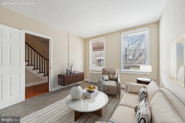 interior space featuring stairs, carpet floors, radiator heating unit, and baseboards