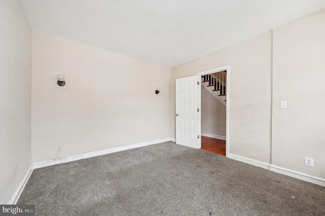 carpeted empty room with baseboards