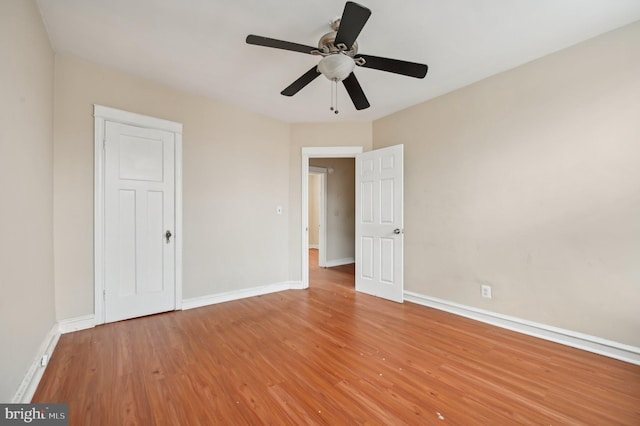 unfurnished bedroom with light wood-style floors, baseboards, and a ceiling fan