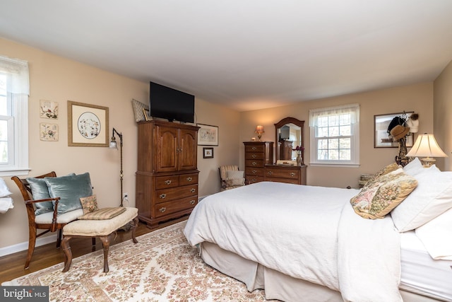 bedroom featuring baseboards and wood finished floors