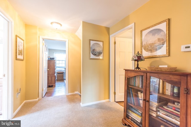 hall with carpet flooring and baseboards