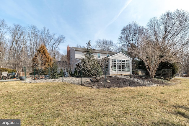 exterior space with a chimney and a yard