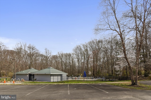 uncovered parking lot with playground community and fence