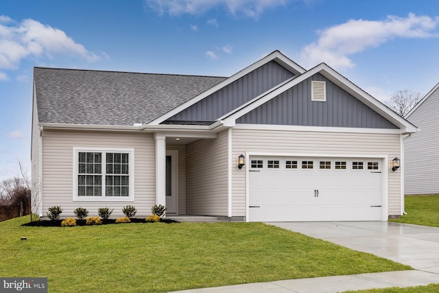 view of front of property with an attached garage, concrete driveway, roof with shingles, a front lawn, and board and batten siding