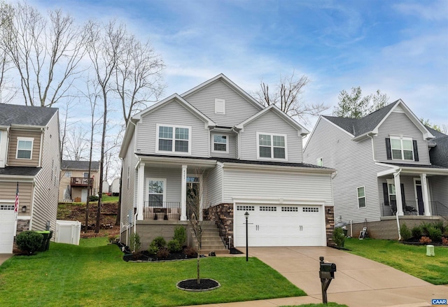 view of front facade with covered porch, driveway, a front yard, and a garage