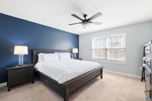 bedroom featuring light carpet, ceiling fan, visible vents, and baseboards