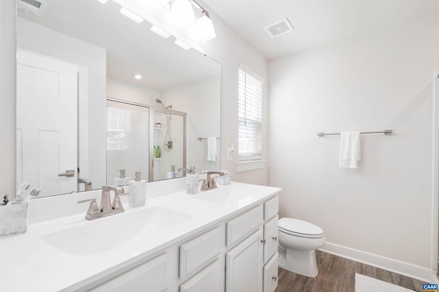 bathroom featuring a stall shower, visible vents, and a sink