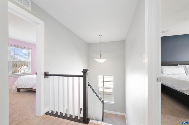 stairs featuring carpet flooring, visible vents, and baseboards