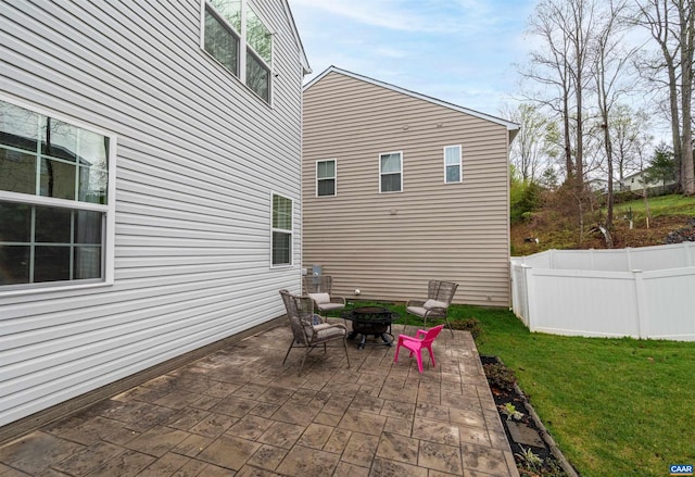 view of patio / terrace with a fire pit and fence