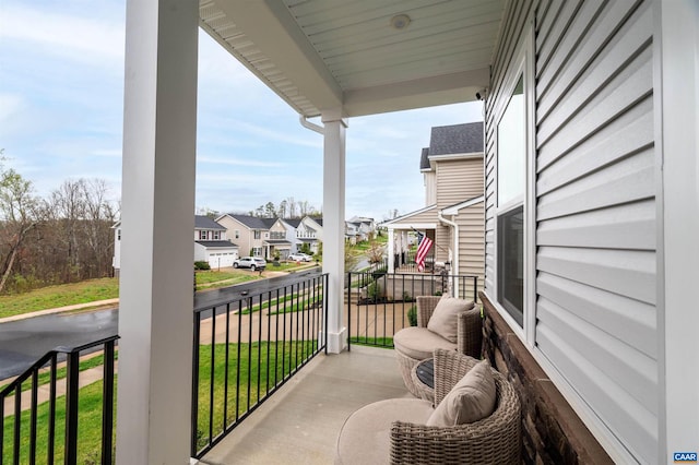 balcony featuring covered porch and a residential view