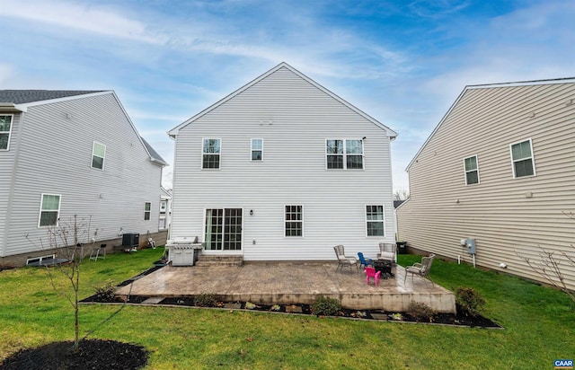 back of property with a yard, a patio area, and central air condition unit