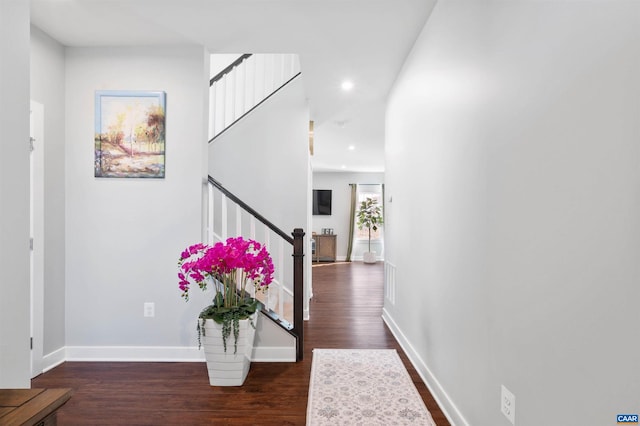 entrance foyer with visible vents, baseboards, dark wood-style floors, stairs, and recessed lighting