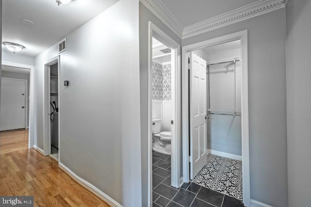 hallway featuring visible vents, baseboards, and tile patterned floors