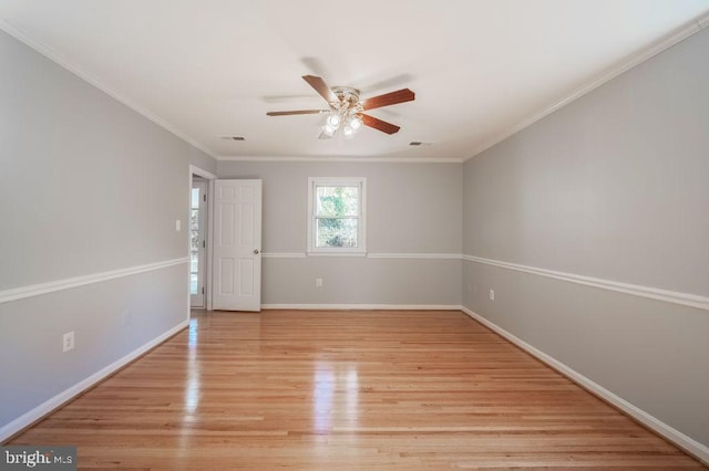 unfurnished room with baseboards, crown molding, visible vents, and light wood-style floors