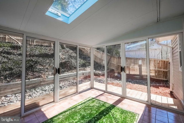 unfurnished sunroom with lofted ceiling with skylight