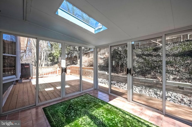 unfurnished sunroom featuring vaulted ceiling with skylight