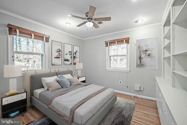 bedroom featuring baseboards, ornamental molding, a ceiling fan, and light wood-style floors