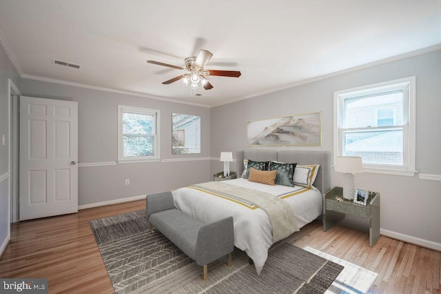 bedroom featuring multiple windows, wood finished floors, and visible vents