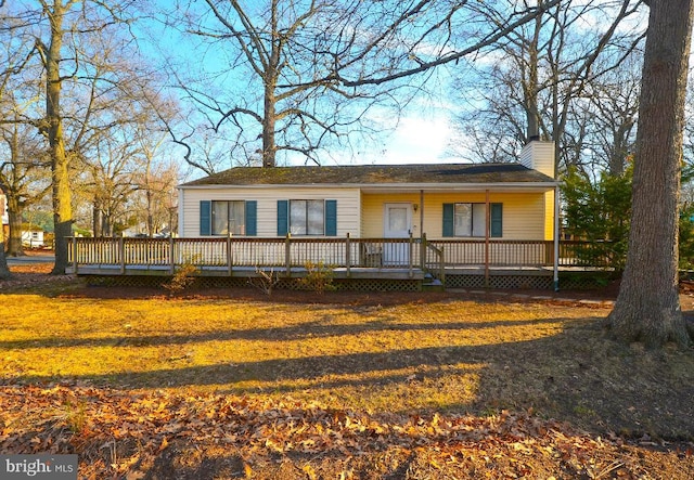 view of front of property with a front yard and a chimney