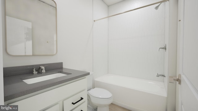 bathroom featuring toilet, shower / washtub combination, and vanity