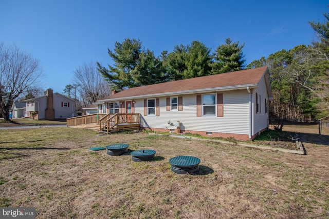 ranch-style home with a front yard, crawl space, and a wooden deck