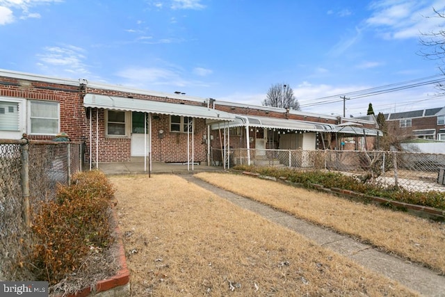 view of front of house featuring a fenced front yard and brick siding