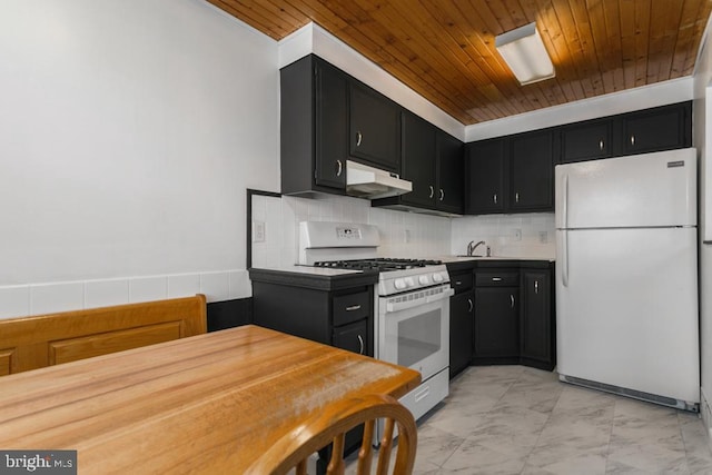 kitchen with white appliances, wood ceiling, marble finish floor, dark cabinetry, and under cabinet range hood