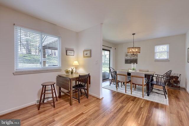 dining room with baseboards and light wood finished floors