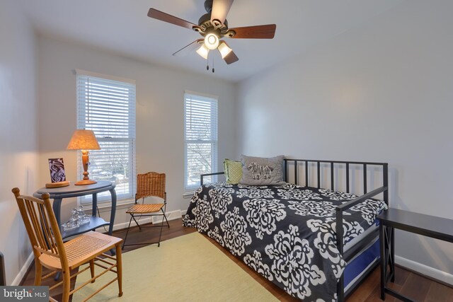 bedroom featuring ceiling fan, wood finished floors, and baseboards