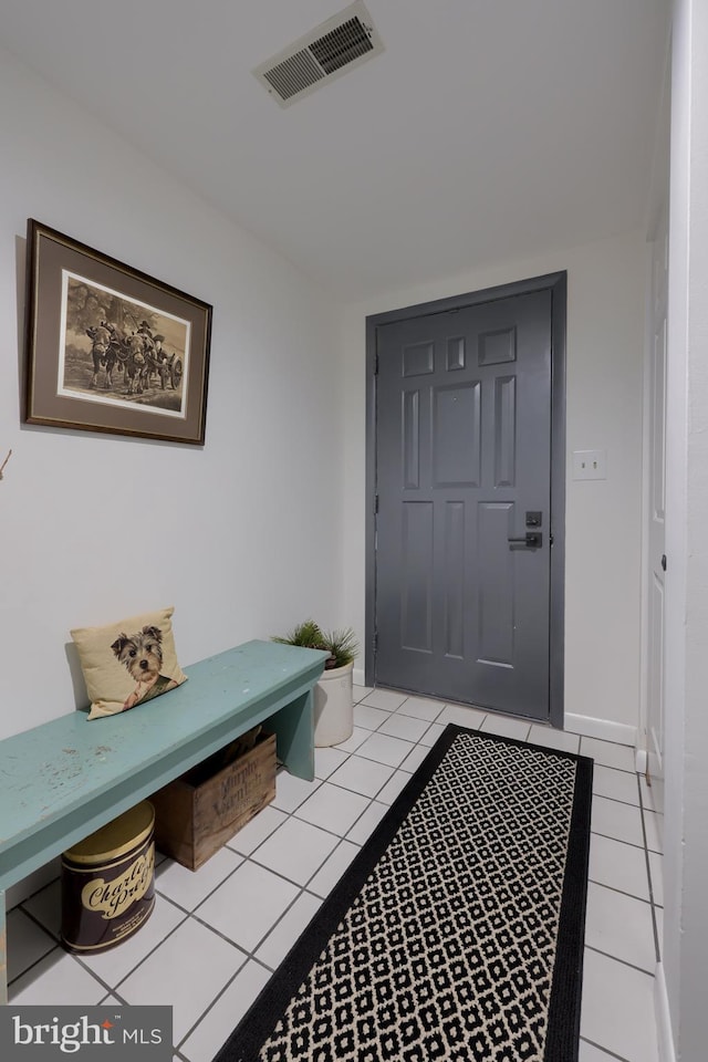 interior space with baseboards, visible vents, and light tile patterned flooring