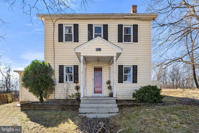 view of front of home featuring a chimney